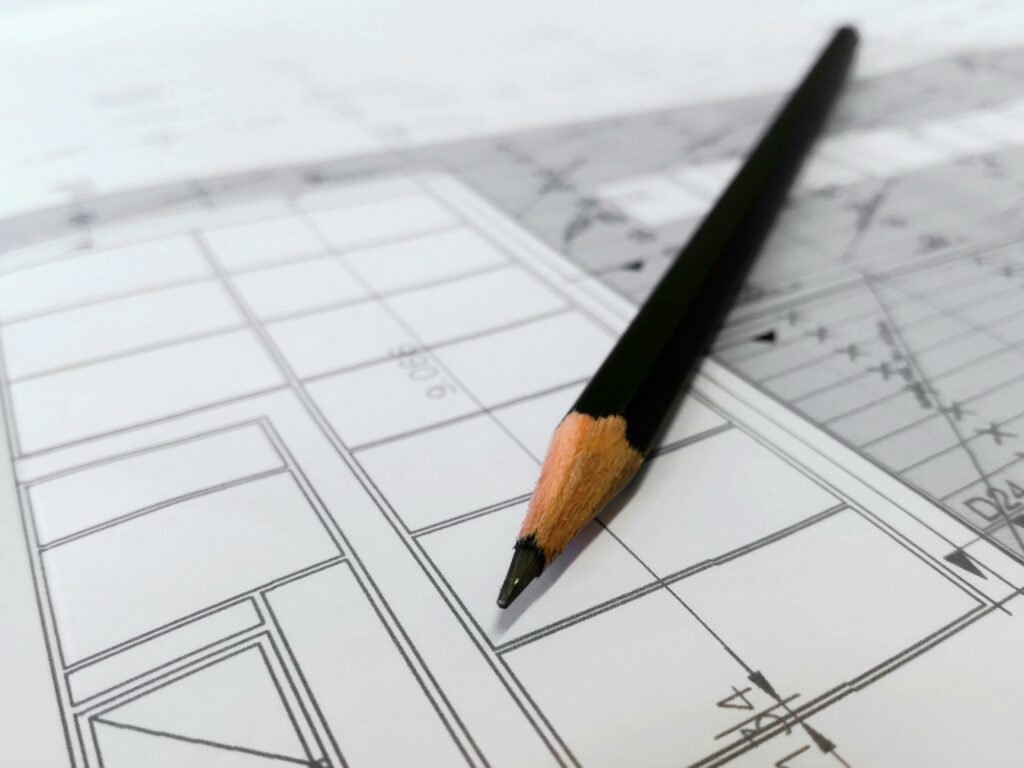 pexels-photo-268362-268362-1 Detailed image of a black pencil resting on architectural blueprints, ideal for design and planning themes.